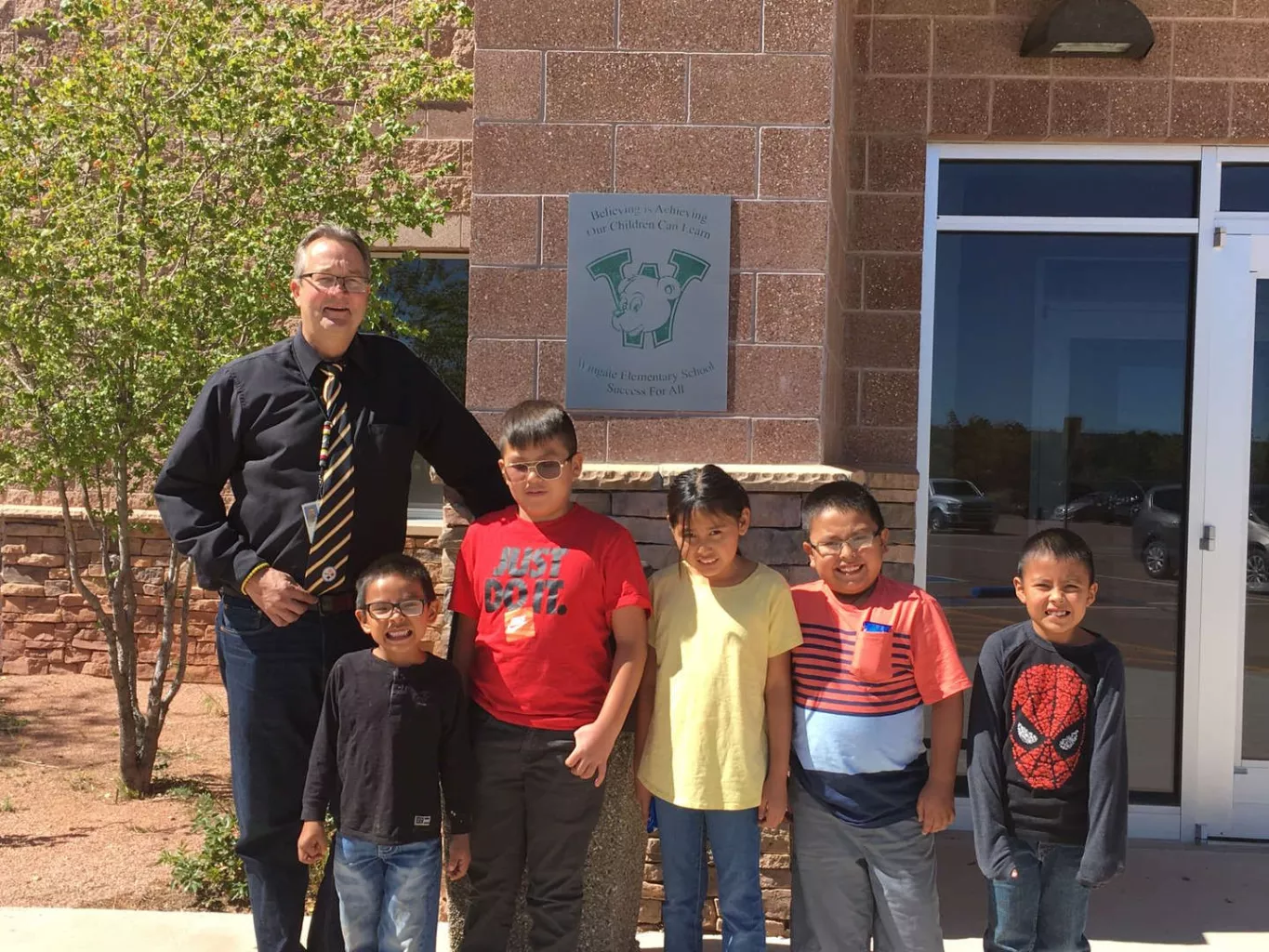 Principal North with students in front of school