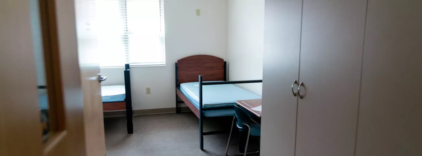 Wingate Elementary School Dorm Room with Beds, a Desk and Closet.