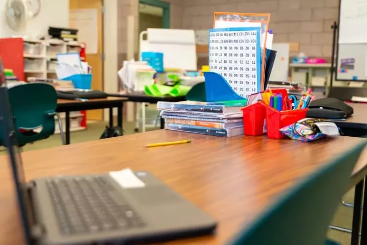 Student Desk with Laptop and Various School Supplies On Top