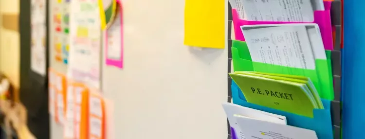Colorful Organizers Hanging on Vertical Shelf Containing Various Forms for Wingate Elementary School